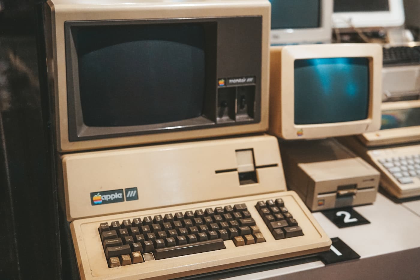 A row of early personal computers on a desk