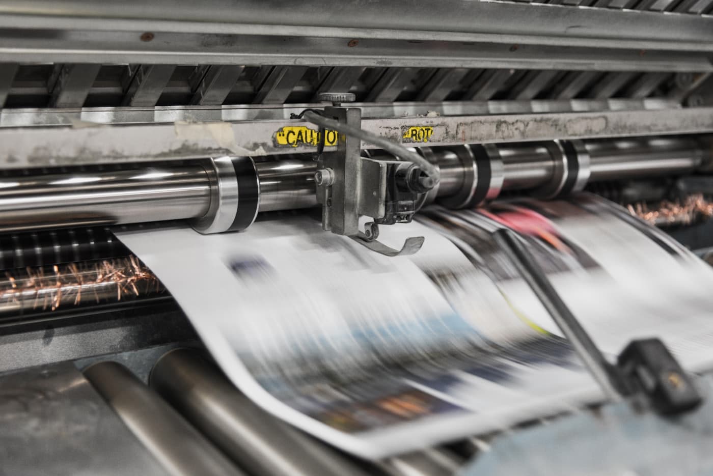 A newspaper press mid-run