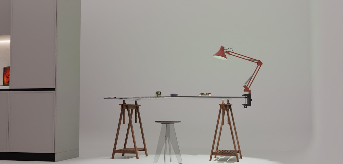 A studio drafting table under an anglepoise lamp