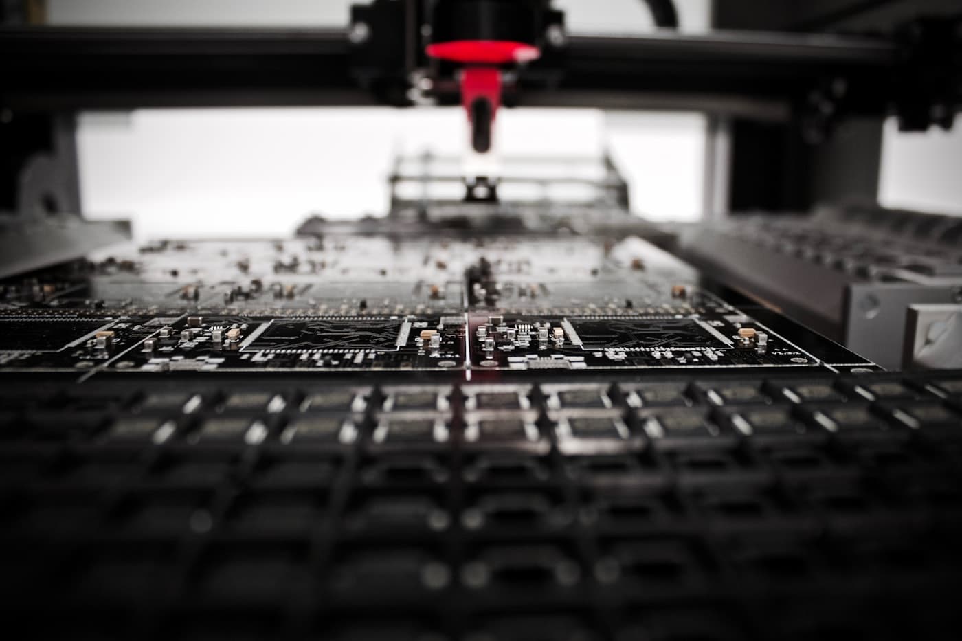 A pick-and-place head above a circuit board